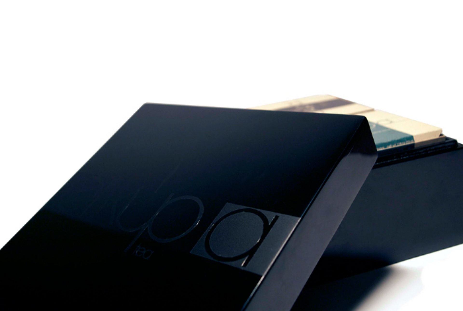 The case with its lid ajar, the wordmark in matte against the gloss