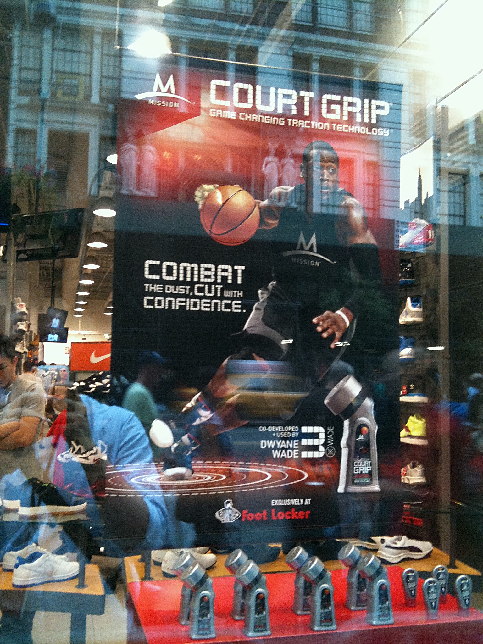 The window banner from the street, the building opposite reflected across it